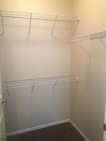 a walk in closet in a bedroom at Courtyard Apartments, Moorhead, 56560